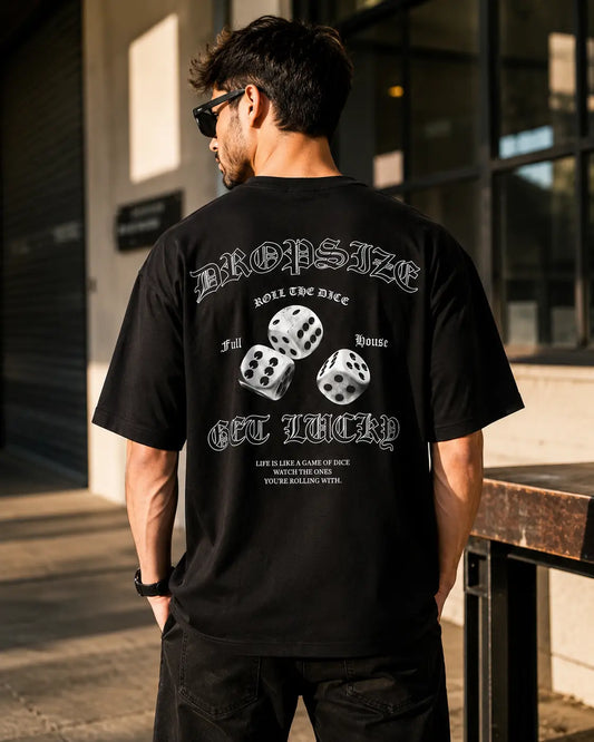 Lifestyle back view of a black oversized T-shirt featuring a bold dice graphic print with a relaxed streetwear fit