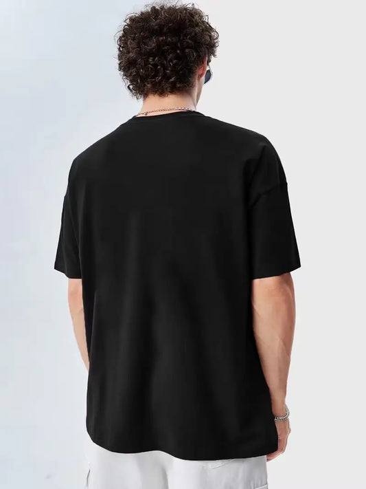 Back view of a black oversized 100% cotton jersey T-shirt (170–180 GSM) with a relaxed streetwear fit.