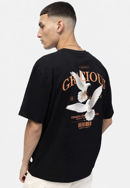 Back view of a black oversized T-shirt featuring a large white script graphic print on the back.